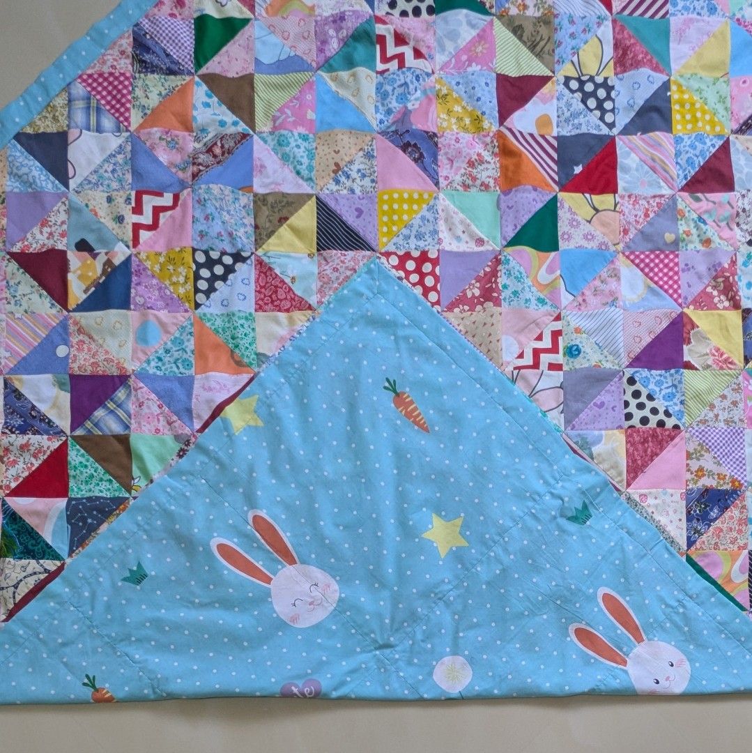 Cotton Patchwork Blanket (Category: Bedding & Towels) located in Singapore. Submitted by hiangneo (Listing ID 1465634642, Image 2). Description: Cotton patchwork blanket, patched with 1440 pcs of tiny triangular fabrics. Rabbit design with blue and polka dot cotton fabric backing. Fine workmanship. Adult size: 69" x 58.5" (179cm X 149cm). Cash on collection at Tiong Bahru MRT. .