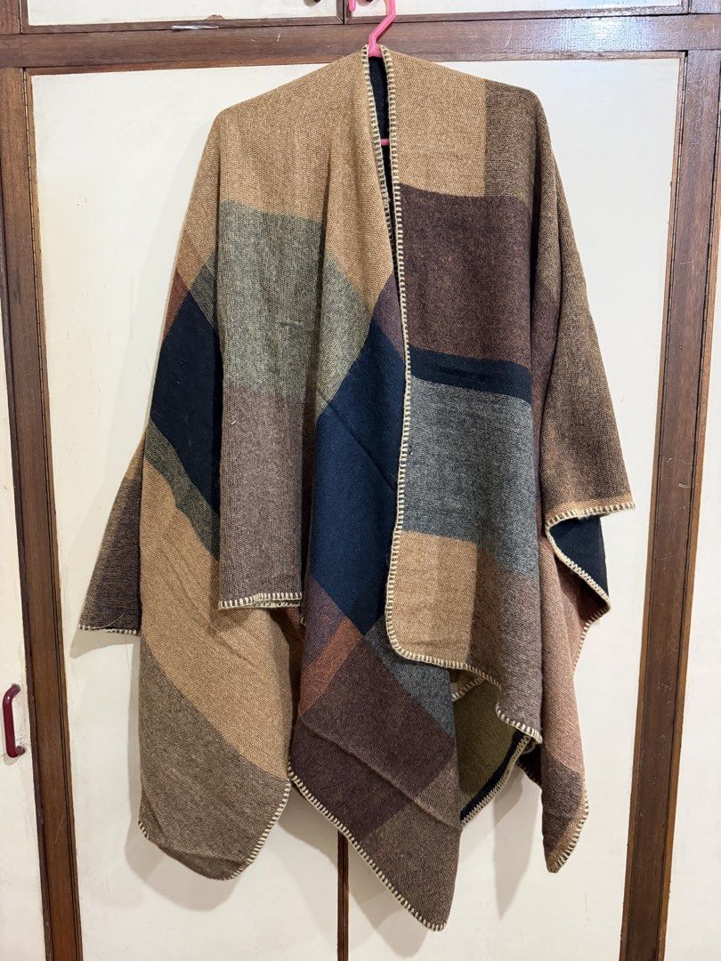 Cozy Colour Block Blanket Poncho Cape Shawl (Category: Scarves) located in Manila. Submitted by preloved_new_forsale (Listing ID 1465639756, Image 1). Description: - Color block poncho in earth tones (brown, navy, olive green, and tan) - Soft woven fabric with stylish decorative blanket stitch edges - Great layering piece for cooler weather or air-conditioned rooms - Easy to throw over any casual outfit - Free size / one-size-fits-all design.