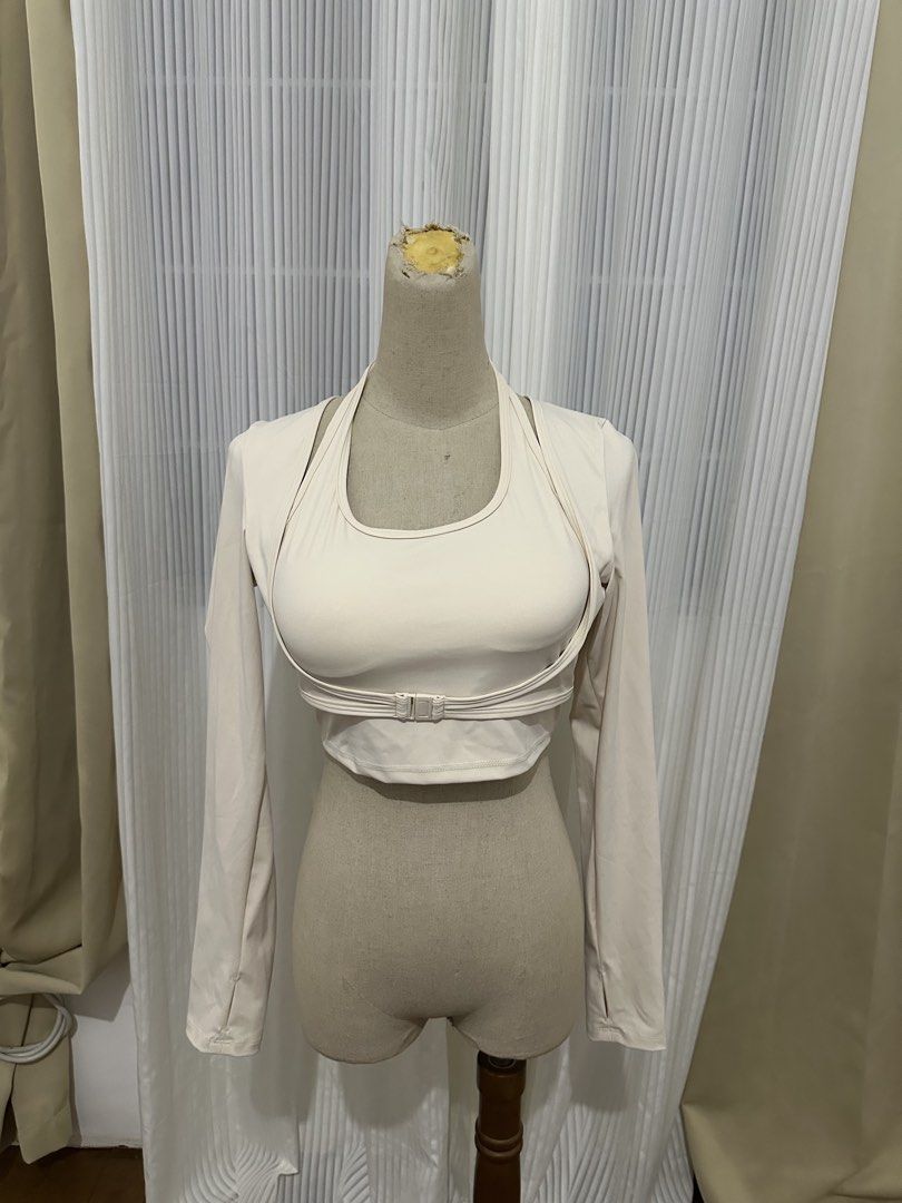 Cream Long Sleeve Crop Top with Halter Layer (Category: Longsleeves) located in Taguig. Submitted by kokombeer (Listing ID 1465753432, Image 1). Description: - Color: Cream - Style: Long sleeve crop top with built-in halter neckline layer - Details: Trendy front buckle under the chest and functional thumbholes - Fabric: Soft, high-stretch athletic material for ultimate comfort - Versatility: Ideal for gym workouts, yoga, or stylish casual everyda