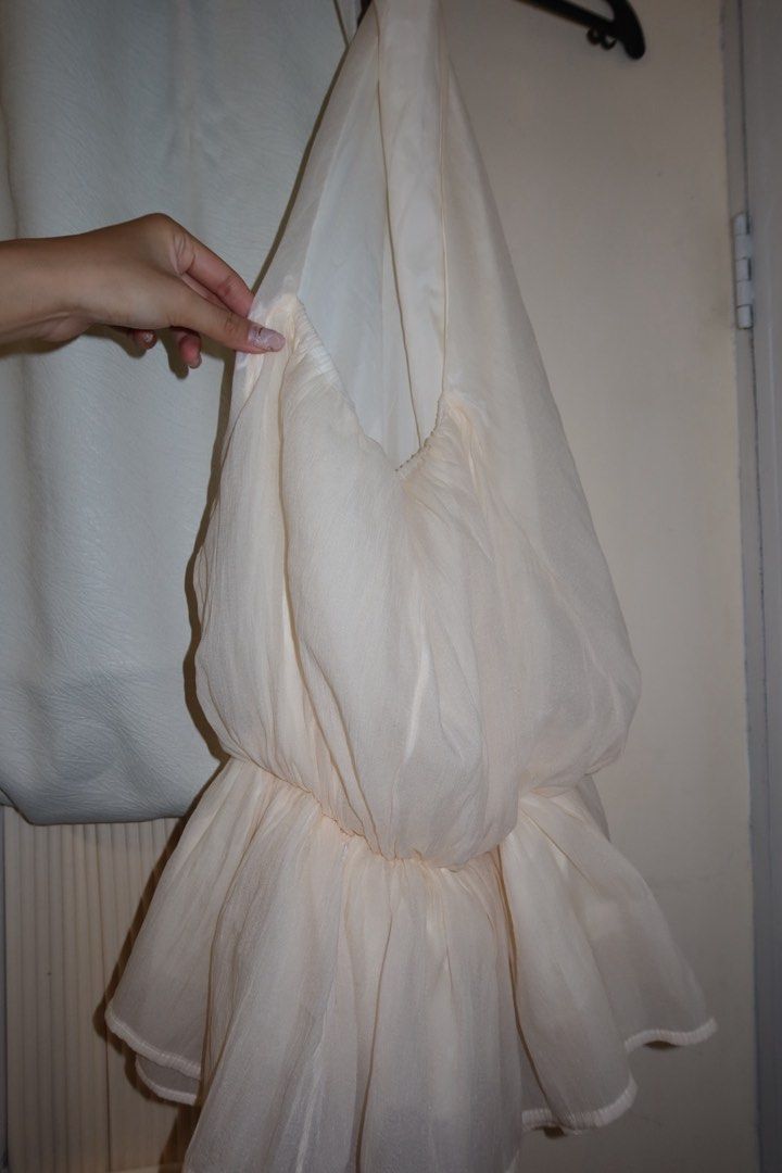 Cream White Halter Neck Backless Dress (Category: Dresses) located in Cavite. Submitted by mcjkim (Listing ID 1465675925, Image 3). Description: - Color: Cream - Style: Halter neck, backless with cute back bow tie - Design: Two-layer construction with structured waist and flowy chiffon skirt - Material: Lightweight chiffon - Condition: Worn once for a Christmas party / like new.