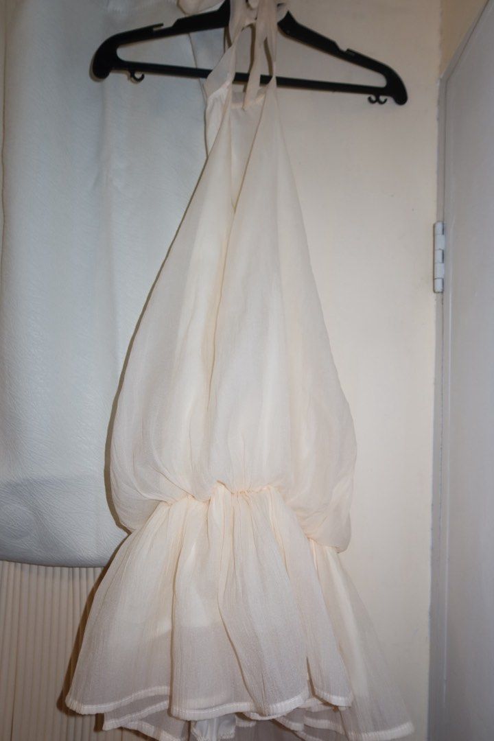 Cream White Halter Neck Backless Dress (Category: Dresses) located in Cavite. Submitted by mcjkim (Listing ID 1465675925, Image 2). Description: - Color: Cream - Style: Halter neck, backless with cute back bow tie - Design: Two-layer construction with structured waist and flowy chiffon skirt - Material: Lightweight chiffon - Condition: Worn once for a Christmas party / like new.