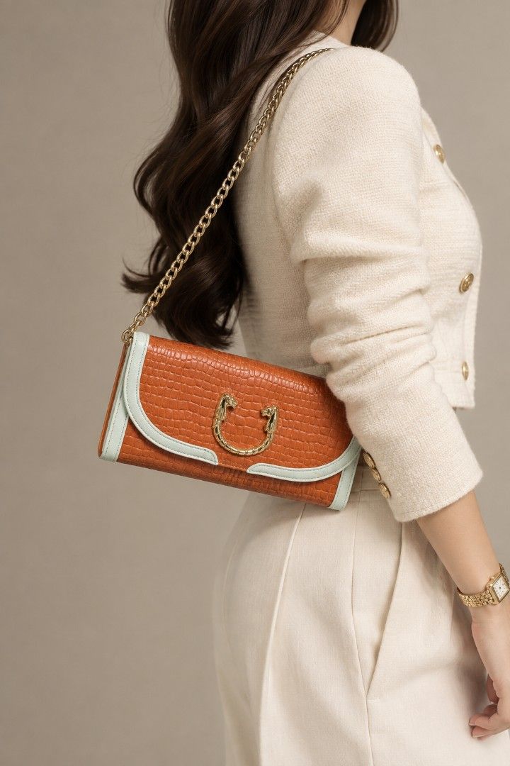 Croco Embossed Two-way Baguette/Clutch Bag (Category: Clutches) located in Baguio. Submitted by PreiLoveMaria (Listing ID 1465593894, Image 1). Description: Croco Embossed Two-way Baguette/Clutch Bag Featuring contrasting white trim details, a unique statement ring clasp with animal head accents on the front, and a versatile chain strap, it easily transforms from a classy clutch to an elegant shoulder bag. Perfect for dates, parties, or special e