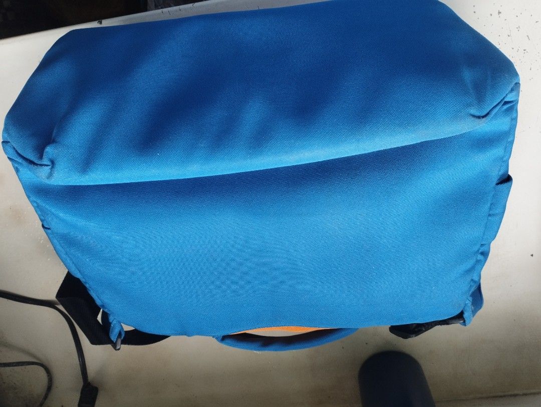 Crumpler Messenger Bag Blue Orange (Category: Sling Bags) located in Manila. Submitted by happycaps (Listing ID 1465662163, Image 2). Description: - Brand: Crumpler - Color: Bright blue and orange with black strap and green interior - Material: Durable canvas - Closure: Secure clips and velcro - Features: Adjustable strap with quick-release buckles and a zippered black mesh pocket inside - Best for: Everyday use, school, or commute Issue: - very 