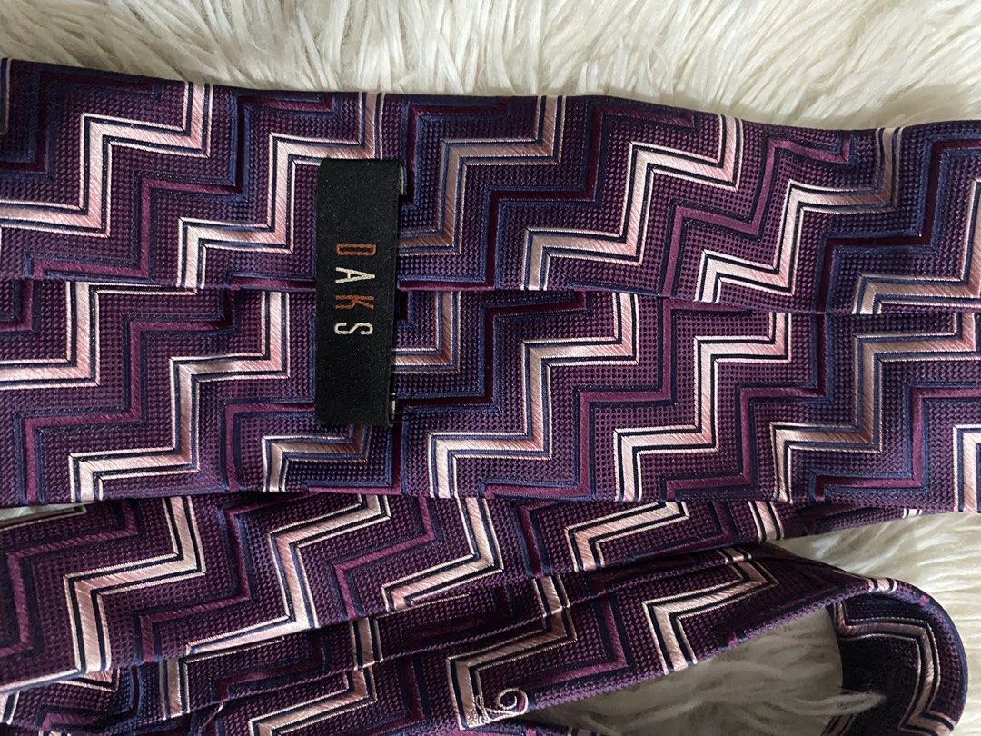 DAKS Purple Chevron Zigzag Pattern Silk Necktie (Category: Ties) located in Bulacan. Submitted by rich2545 (Listing ID 1465581438, Image 3). Description: - Brand: DAKS - Design: Bold zigzag chevron pattern in purple, pink, white, and dark purple - Style: Classic pointed tail, standard width - Material: High-quality woven fabric with a nice texture - Condition: Clean and well-maintained - Occasion: Ideal for business attire, formal events, or smar