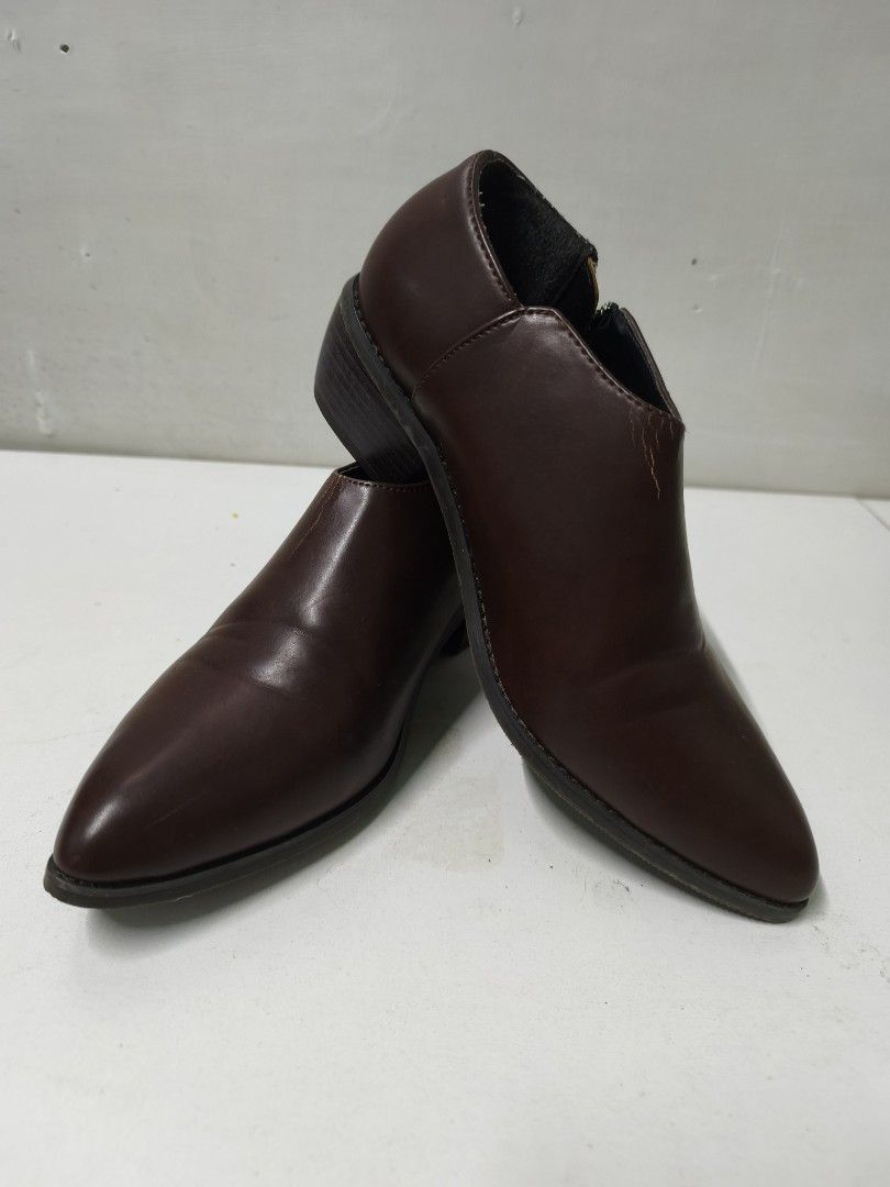 Dark Brown Pointed Toe Ankle Boots (Category: Boots) located in San Jose del Monte. Submitted by missalipot (Listing ID 1465746639, Image 1). Description: - Color: Dark brown - Material: Smooth faux leather - Design: Pointed toe with a low block heel for comfortable daily wear - Closure: Convenient side zip - Fit: Standard sizing, ideal for work or casual outings - Condition: Minor scuffing visible near the ankle collar.