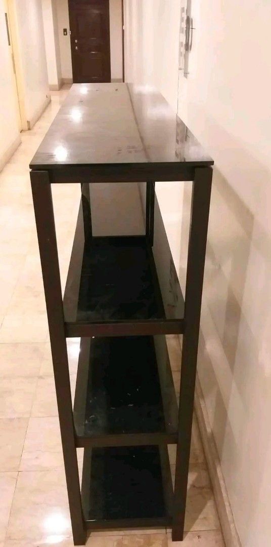 Dark brown wooden 4-tier open display shelf bookshelf (Category: Shelves, Cabinets & Racks) located in Taguig. Submitted by thrifthub.ph (Listing ID 1465667607, Image 2). Description: Condo Pull-out!! 4 tier Dark brown wood with glass on top each layer.Has minor issue,d naman halata.malaki po ito at makapal yung mga glass nya. Pwede pa pick up sa lalamove,if No time pumonta sa house. Loc.Central signal,Taguig city.