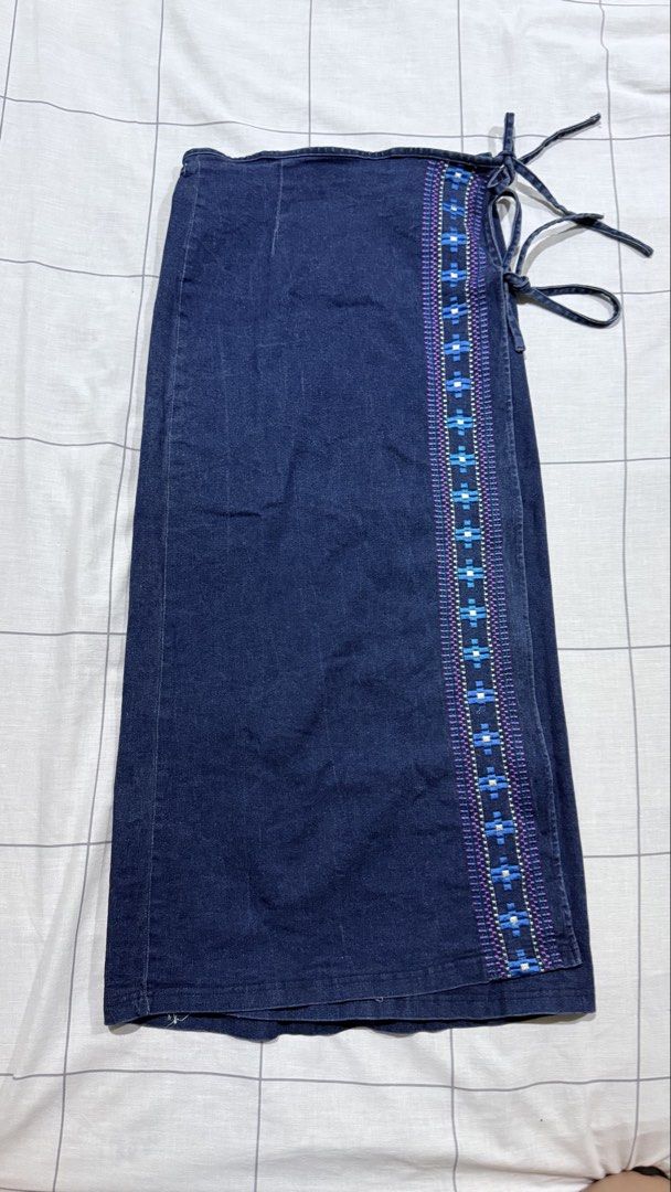 Dark denim wrap skirt with embroidered border (Category: Skirts) located in Taytay. Submitted by chichays (Listing ID 1465581740, Image 1). Description: - Dark denim wrap skirt with a flattering midi length - Adjustable side tie closure for a customized, comfortable waist fit - Eye-catching blue, white, and purple geometric embroidery along the front edge - perfect for xxs-xs girly.