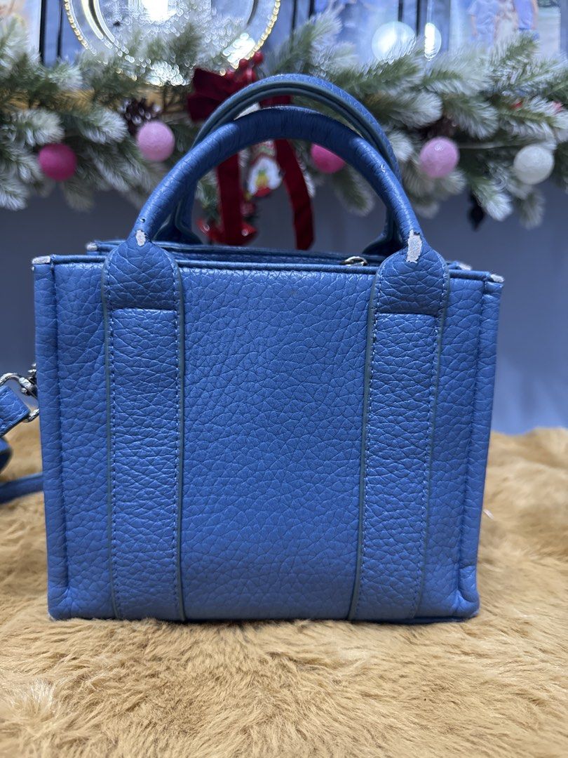 David Jones Blue Tote Handbag (Category: Tote Bags) located in Alaminos. Submitted by jhean1323 (Listing ID 1465584323, Image 2). Description: - Brand: David Jones - Color/Material: Blue pebble textured faux leather - Versatile carry: Dual top handles and a detachable crossbody strap - Secure closure: Zip top - Interior features: Beige fabric lining, one zipper pocket, and metal brand logo plate - Size: Compact, ideal for everyday use - Condition