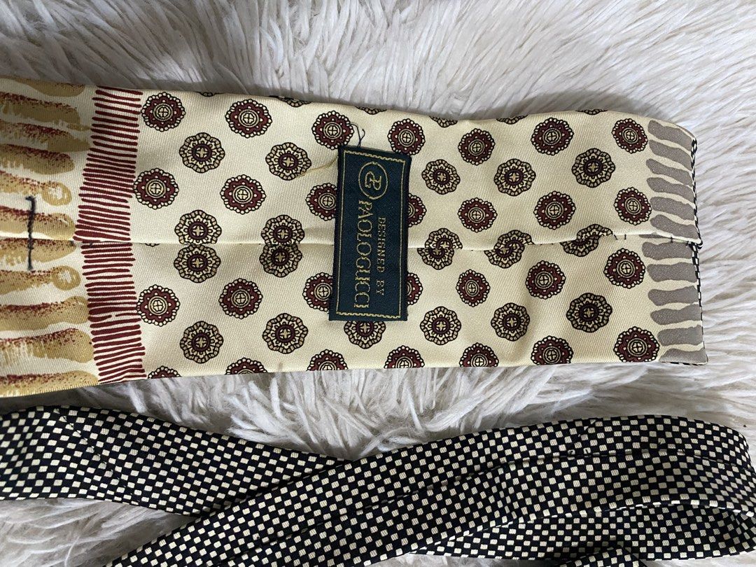 Designed by Paolo Gucci Silk Necktie (Category: Ties) located in Bulacan. Submitted by rich2545 (Listing ID 1465581657, Image 2). Description: - Authentic Paolo Gucci multi-pattern necktie - Features black and white grid, striped motifs, and burgundy geometric floral medallions on cream fabric - Standard length with a classic pointed tip - Label stitching intact on the back keeper loop - Perfect statement accessory for formal wear or office outfi