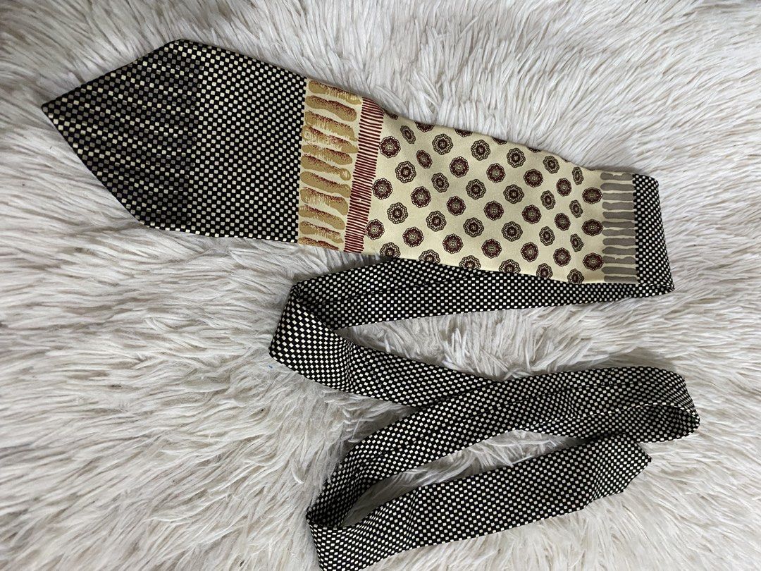 Designed by Paolo Gucci Silk Necktie (Category: Ties) located in Bulacan. Submitted by rich2545 (Listing ID 1465581657, Image 1). Description: - Authentic Paolo Gucci multi-pattern necktie - Features black and white grid, striped motifs, and burgundy geometric floral medallions on cream fabric - Standard length with a classic pointed tip - Label stitching intact on the back keeper loop - Perfect statement accessory for formal wear or office outfi