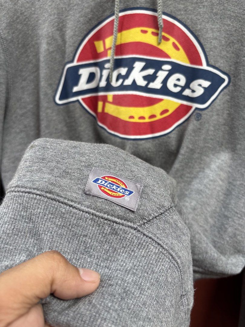Dickies Grey Hoodie Sweatshirt Size M (Category: Hoodies) located in Manila. Submitted by thriftkibs (Listing ID 1465656984, Image 3). Description: - Brand: Dickies - Color: Grey - Size: Medium - Material: 100% cotton - Design: Big chest logo print, front pouch pocket with woven Dickies patch - Features: Drawstring hood, ribbed cuffs and hem - Condition: Great casual piece with clean inner tags.