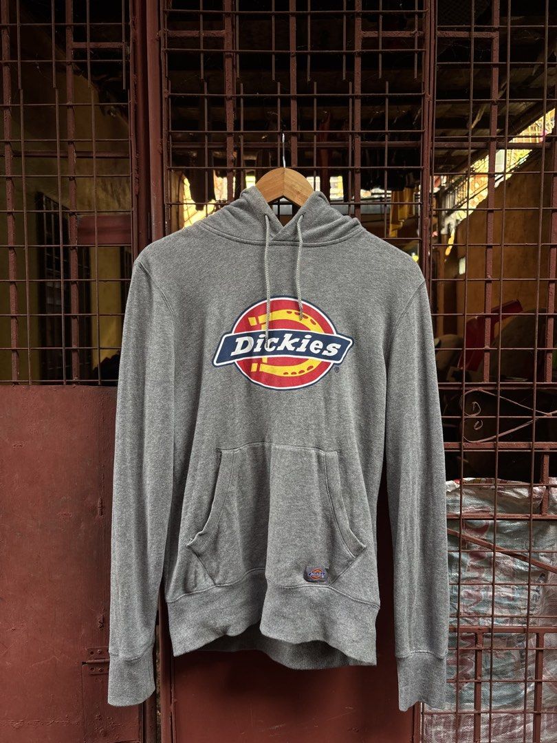 Dickies Grey Hoodie Sweatshirt Size M (Category: Hoodies) located in Manila. Submitted by thriftkibs (Listing ID 1465656984, Image 1). Description: - Brand: Dickies - Color: Grey - Size: Medium - Material: 100% cotton - Design: Big chest logo print, front pouch pocket with woven Dickies patch - Features: Drawstring hood, ribbed cuffs and hem - Condition: Great casual piece with clean inner tags.
