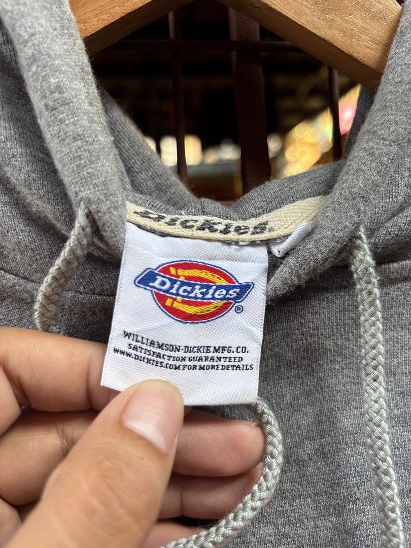 Dickies Grey Hoodie Sweatshirt Size M (Category: Hoodies) located in Manila. Submitted by thriftkibs (Listing ID 1465656984, Image 2). Description: - Brand: Dickies - Color: Grey - Size: Medium - Material: 100% cotton - Design: Big chest logo print, front pouch pocket with woven Dickies patch - Features: Drawstring hood, ribbed cuffs and hem - Condition: Great casual piece with clean inner tags.