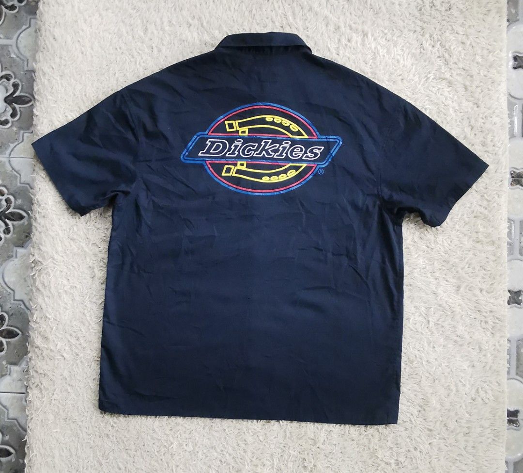 Dickies Short Sleeve Button Down Work Shirt Navy Blue (Category: Tshirts & Polo Shirts ) located in Davao. Submitted by dmp1993 (Listing ID 1465692856, Image 2). Description: Dark navy blue Dickies short sleeve button down shirt. Big bold Dickies graphic printed on the back. DKS text logo printed on the left sleeve. Two buttoned chest pockets on the front. Classic collar style with dark buttons down the front. Small Dickies tag near the bottom he