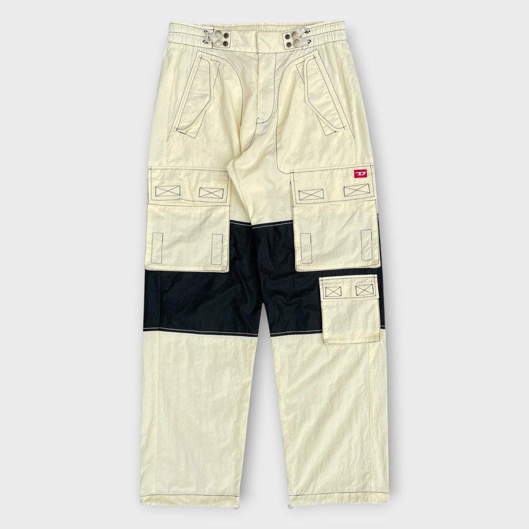 Diesel - Beige Nylon Cargo Pants (Category: Activewear) located in Los Banos. Submitted by declutterking (Listing ID 1465717739, Image 2). Description: Size 32 on tag Paneled plain-woven nylon cargo pants. Adjustable bungee-style button tab fastening at waistband and cuffs. · Zip-fly · Four-pocket styling · Flap pockets and textile logo patch at front · Polyurethane-coated panel at knees. Dimensions: 16.25" waist 12.25" front rise 44" length 9.25