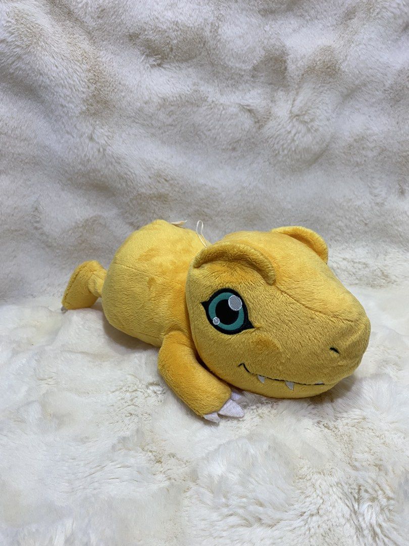 Digimon “laying Agumon” plush (Category: Plushies & Soft Toys) located in Kalibo. Submitted by ollie_stuffshop (Listing ID 1465586626, Image 1). Description: Length: 35cm Before you send your inquiries: ❗️Last Price is already posted ❗️Manage your expectations, WYSIWYG ❗️May need washing ❗️Dropoff is every Wednesday & Sunday - Banpresto on label but faded.