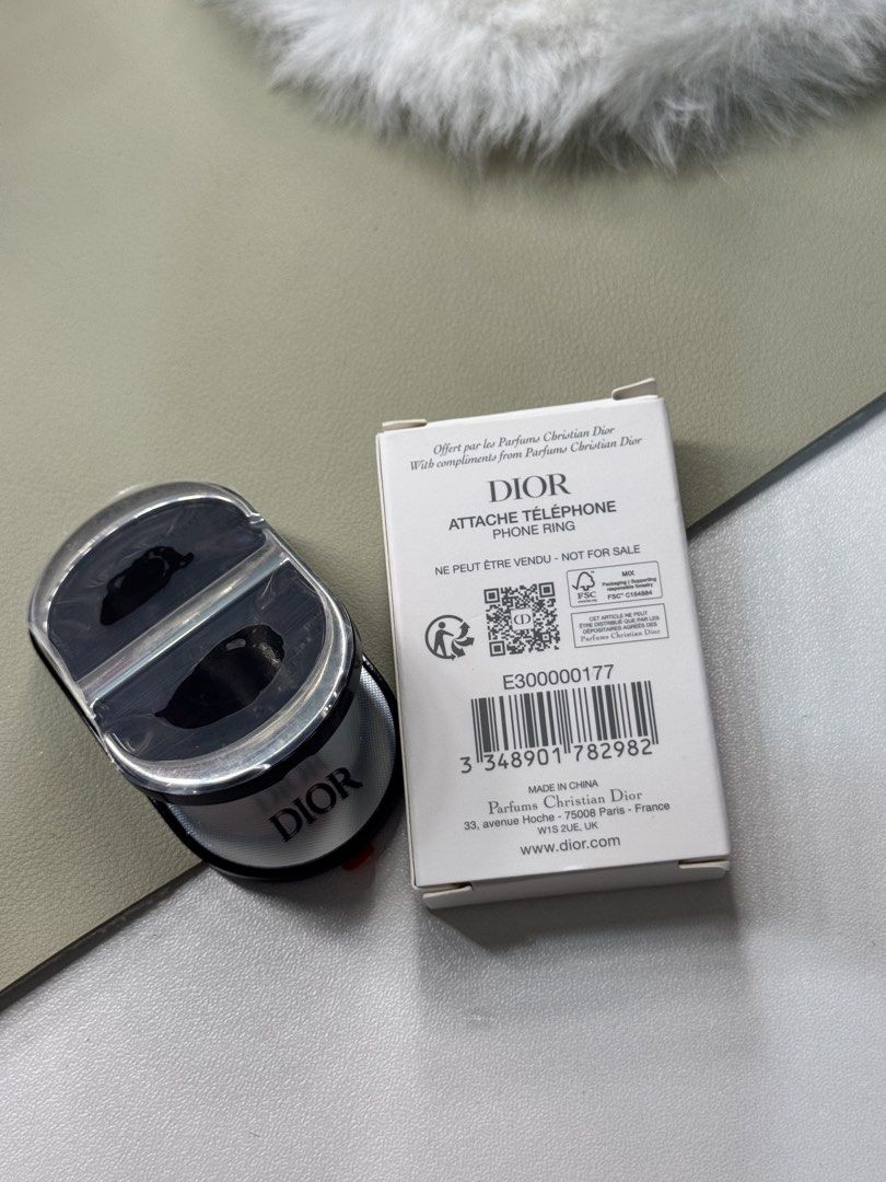 Dior Phone Ring Attache Telephone (Category: Mounts & Holders) located in Binan City. Submitted by seoulbeauty_cart (Listing ID 1465586869, Image 2). Description: - 100% Authentic Christian Dior promotional item (Not for Sale) - Brand new and unused, comes in original white box packaging - Sleek oval design featuring a clear upper section - Stylish Dior branding accented on the side - Secure grip accessory for any smartphone.