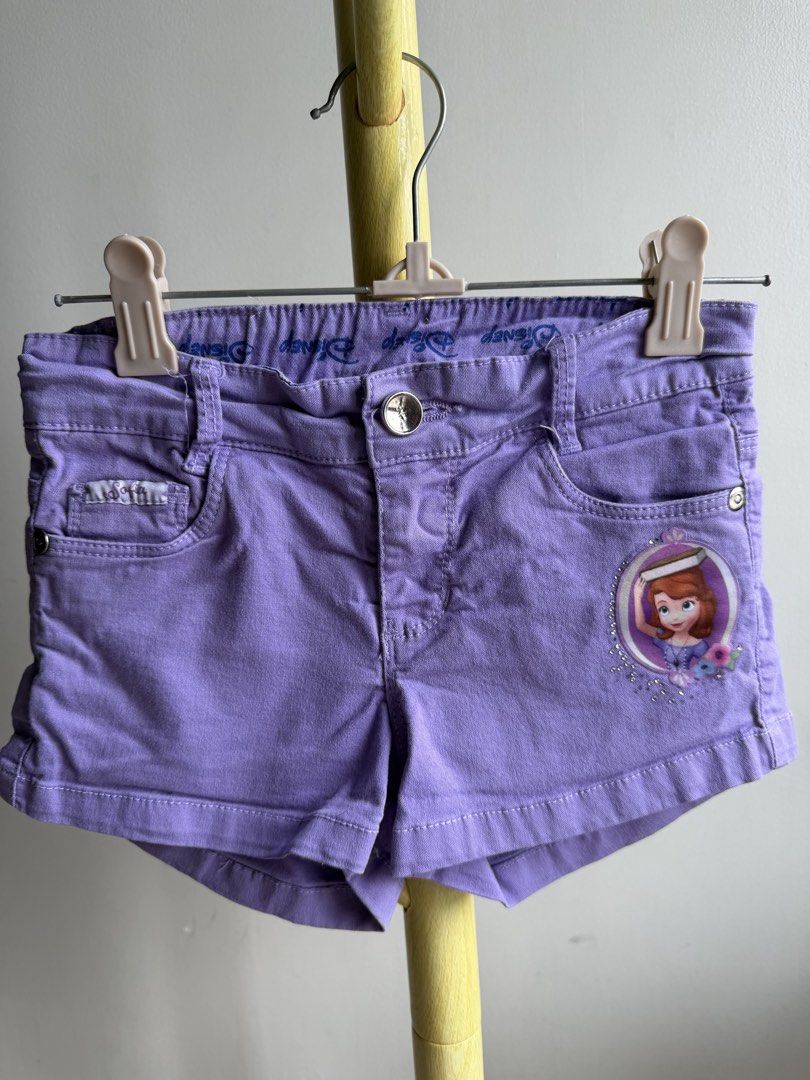 Disney Princess Sofia purple denim shorts (Category: Babies & Kids Fashion) located in Quezon City. Submitted by warmrabbit_414908 (Listing ID 1465595440, Image 1). Description: - Authentic Disney Sofia the First purple denim shorts - Features a sparkly framed Sofia print on the left leg and a small Sofia label on the coin pocket - Detailed with a back right pocket embroidered crest patch and branded interior waistband - Shiny silver button closu