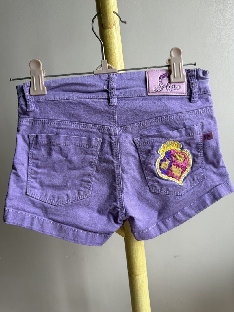 Disney Princess Sofia purple denim shorts (Category: Babies & Kids Fashion) located in Quezon City. Submitted by warmrabbit_414908 (Listing ID 1465595440, Image 2). Description: - Authentic Disney Sofia the First purple denim shorts - Features a sparkly framed Sofia print on the left leg and a small Sofia label on the coin pocket - Detailed with a back right pocket embroidered crest patch and branded interior waistband - Shiny silver button closu
