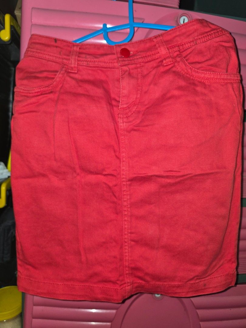 Divided by H&M Red Denim Skirt (Category: Skirts) located in Manila. Submitted by _sj1204 (Listing ID 1465615763, Image 1). Description: - Brand: Divided by H&M - Color: Bright Red - Material: 98% Cotton, 2% Elastane - Features: Button closure, front pockets - Condition: Noticeable dark spots and stains near the waistband area - Style: Casual staple, easy to pair with tees and sneakers - Waistline: 26-28 inches.