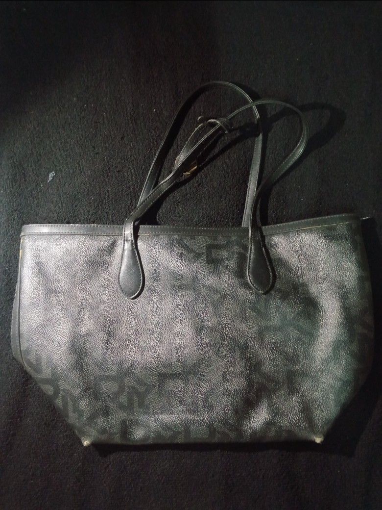 DKNY Black Monogram Tote Bag with Shoulder Straps (Category: Tote Bags) located in Rizal. Submitted by hawt_sawl (Listing ID 1465687790, Image 1). Description: - Brand: DKNY - Color: Classic Black - Material: Textured faux leather with all-over monogram pattern - Straps: Dual shoulder straps with adjustable buckle detail - Interior: Open top design with a spacious and clean lining - Condition: Bottom corners show minor wear, but overall in great,