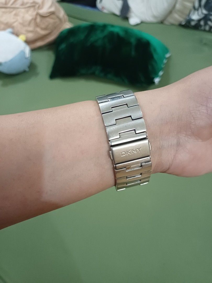 DKNY silver crystal bezel quartz wristwatch (Category: Women's Watches) located in Antipolo. Submitted by momprelovedpage (Listing ID 1465604080, Image 2). Description: - Brand: DKNY - Color: Silver - Design: Round face with subdial and crystal stones on the bezel - Material: Stainless steel link bracelet with clasp closure - Features: Battery-powered analog display, engraved logo on the back clasp - Style: Classic everyday accessory with a touch
