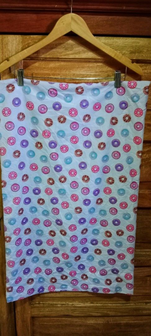 Donut Print Long Pillowcase (Category: Bedding & Towels) located in Mangaldan. Submitted by closetqwin (Listing ID 1465639114, Image 2). Description: -Size 31.5 inches Length and 19.5 inches Width - Material: Soft fabric with a smooth finish and fun colorful donut print (pink, blue, purple, brown with frosting and sprinkles) - Condition: Brand new without tag never been used.