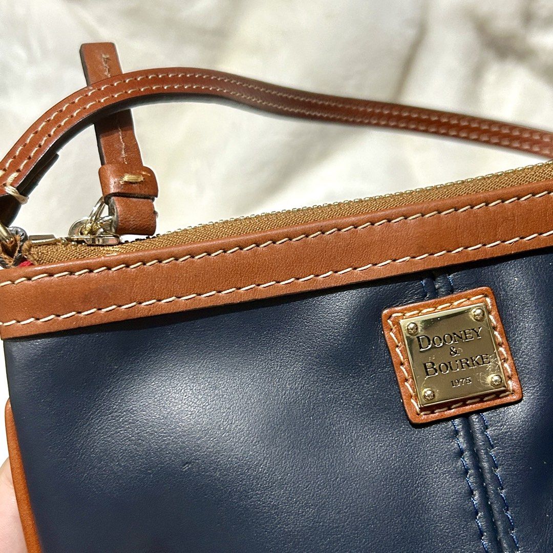 Dooney & Bourke Genuine Leather Wristlet Wallet (Category: Wallets & Card holders) located in Quezon City. Submitted by kitsune.treasures (Listing ID 1465599374, Image 2). Description: *First to pay policy! *1 day reservation only. Failure to pay on time, auto cancel. 📍Quezon City * MOD: J&T | Lalamove * MOP: GCASH | BPI 📦ON HAND AND READY TO SHIP! CONDITION: WHAT YOU SEE IS WHAT YOU GET. Dimensions: Kindly check the photos for the actual measu