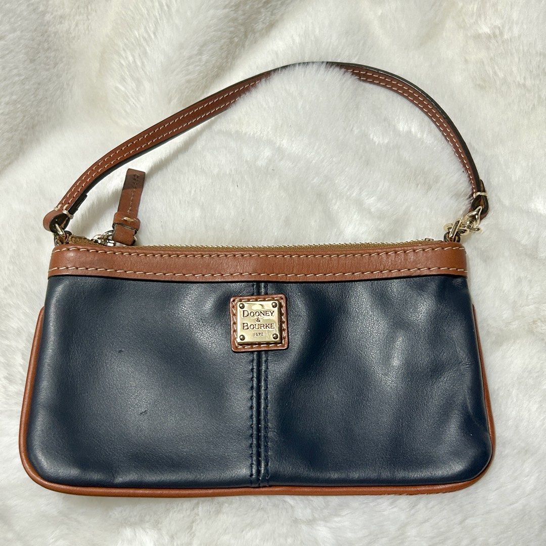 Dooney & Bourke Genuine Leather Wristlet Wallet (Category: Wallets & Card holders) located in Quezon City. Submitted by kitsune.treasures (Listing ID 1465599374, Image 1). Description: *First to pay policy! *1 day reservation only. Failure to pay on time, auto cancel. 📍Quezon City * MOD: J&T | Lalamove * MOP: GCASH | BPI 📦ON HAND AND READY TO SHIP! CONDITION: WHAT YOU SEE IS WHAT YOU GET. Dimensions: Kindly check the photos for the actual measu