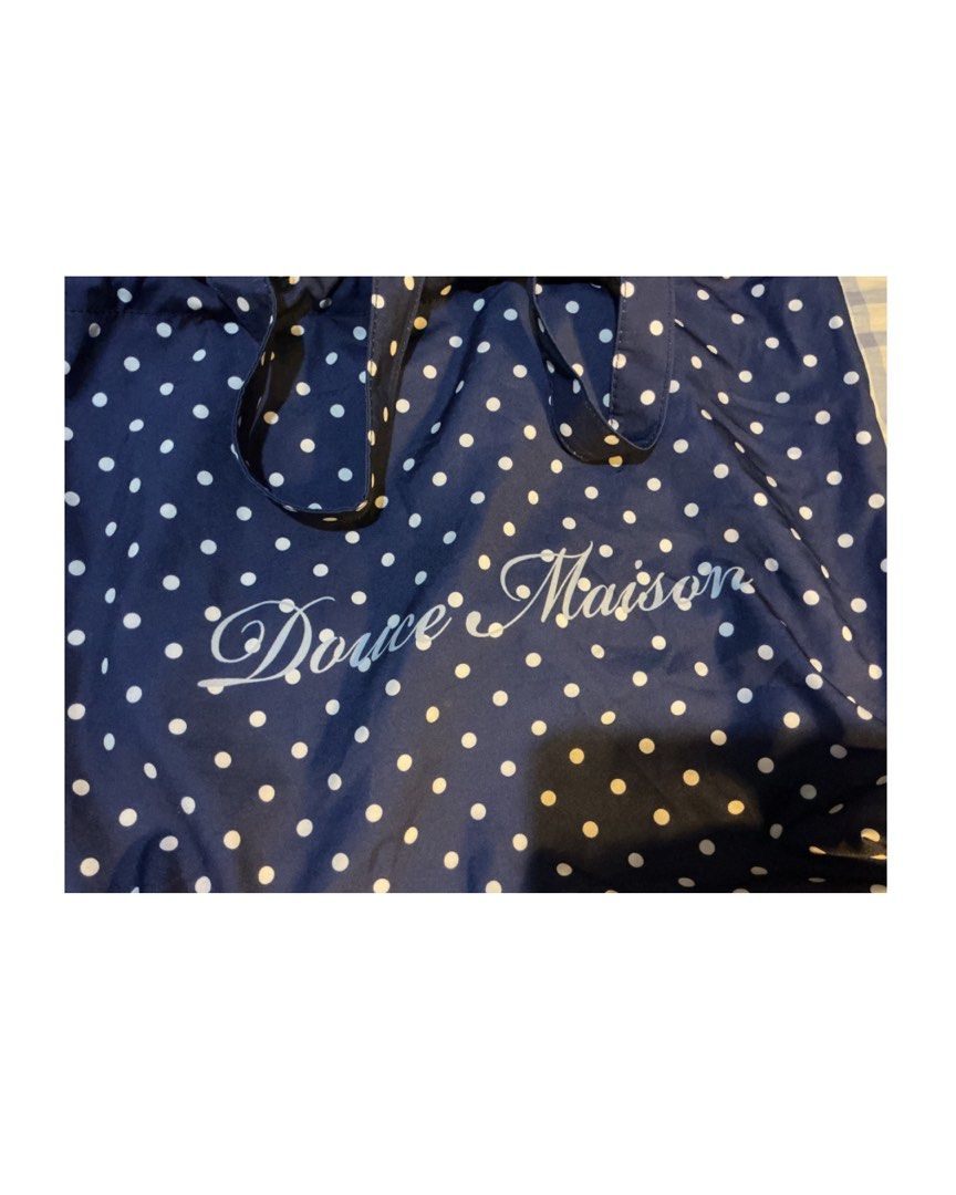 Douce Maison Navy Blue Polka Dot Tote Bag (Category: Tote Bags) located in Bulacan. Submitted by whimsylilies (Listing ID 1465669986, Image 3). Description: - Color & Pattern: Navy blue with white polka dots - Design: Features white 'Douce Maison' script on the front - Features: Double shoulder straps, open top design, and a matching inner pocket - Material: Lightweight fabric - Practicality: Easy to fold up and convenient for daily use.