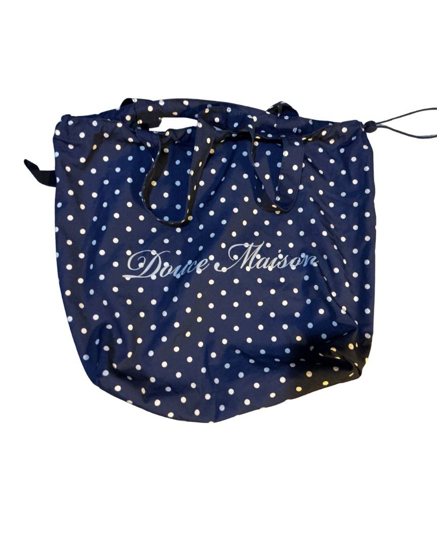 Douce Maison Navy Blue Polka Dot Tote Bag (Category: Tote Bags) located in Bulacan. Submitted by whimsylilies (Listing ID 1465669986, Image 1). Description: - Color & Pattern: Navy blue with white polka dots - Design: Features white 'Douce Maison' script on the front - Features: Double shoulder straps, open top design, and a matching inner pocket - Material: Lightweight fabric - Practicality: Easy to fold up and convenient for daily use.