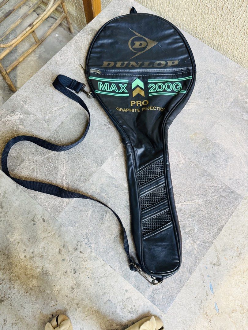 Dunlop Max 200G Pro Graphite Injection Tennis Racket Bag (Category: Racket and Ball Sports) located in Santa Cruz. Submitted by maqui15 (Listing ID 1465582568, Image 1). Description: - Brand/Model: Vintage Dunlop Max 200G Pro tennis racket bag - Material: Premium black leatherette finish with green and gold branding accents - Straps: Includes an adjustable shoulder strap with sturdy metal clips - Pockets: Convenient zippered front pocket for smal
