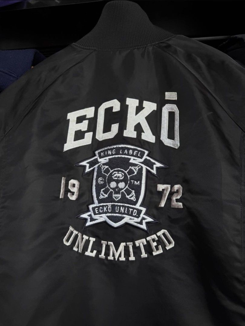 ECKO BOMBER JACKET (Category: Coats, Jackets and Outerwear) located in Manila. Submitted by vastpenguin.fe4763 (Listing ID 1465679649, Image 2). Description: - Black Ecko Unltd. bomber jacket - Full zip closure - Ribbed collar, cuffs, and hem - Ecko Unltd. logo on front and back - Ecko Unltd. text on sleeves - Small chest pocket - Classic bomber style - Dimes: 26x28.