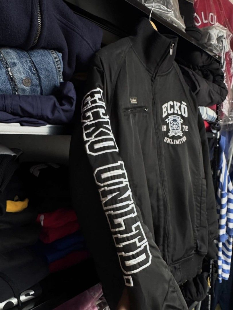ECKO BOMBER JACKET (Category: Coats, Jackets and Outerwear) located in Manila. Submitted by vastpenguin.fe4763 (Listing ID 1465679649, Image 3). Description: - Black Ecko Unltd. bomber jacket - Full zip closure - Ribbed collar, cuffs, and hem - Ecko Unltd. logo on front and back - Ecko Unltd. text on sleeves - Small chest pocket - Classic bomber style - Dimes: 26x28.