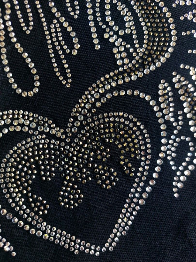 Edikted Black Rhinestone Crop Top Size M (Category: Sleeveless) located in Palayan City. Submitted by akhai420 (Listing ID 1465596889, Image 3). Description: - Brand: Edikted - Size: M - Style: Short sleeve crewneck crop top - Details: Rhinestone graphic featuring a heart, wings, and flame design; pink collar tag with blue text - Material: Soft cotton fabric.