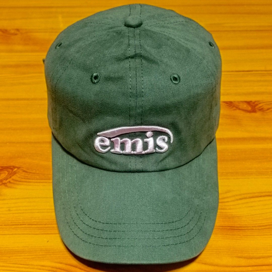 EMIS Green Embroidered Logo Baseball Cap (Category: Caps & Hats) located in Manila. Submitted by caps08 (Listing ID 1465745267, Image 2). Description: - Brand: EMIS (Made in Korea) - Color: Green with white & pink embroidered front logo - Details: White 'E17 - 21' embroidery at the back - Material: 100% cotton (Manufacture date: 2023.12) - Fit: Adjustable strap with metal buckle - Condition: Clean fabric and solid structure.