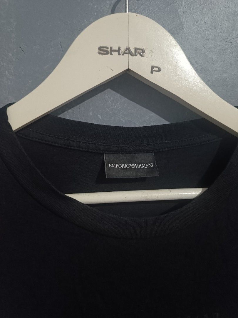 Emporio Armani Black Graphic Tee (Category: Tshirts & Polo Shirts ) located in Iloilo. Submitted by wendxcz-thrift- (Listing ID 1465706308, Image 3). Description: - Brand: Emporio Armani - Color: Black - Style: Short-sleeve crew neck t-shirt - Design: Tonal layered block logo on chest - Material: Soft and breathable cotton for daily wear - Authenticity: Includes tagged neckline and authentic Certilogo tag - Condition: Clean with no flaws or fadin