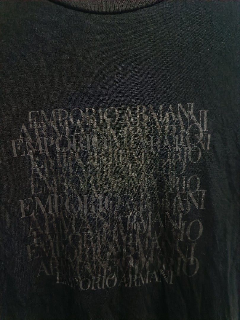 Emporio Armani Black Graphic Tee (Category: Tshirts & Polo Shirts ) located in Iloilo. Submitted by wendxcz-thrift- (Listing ID 1465706308, Image 2). Description: - Brand: Emporio Armani - Color: Black - Style: Short-sleeve crew neck t-shirt - Design: Tonal layered block logo on chest - Material: Soft and breathable cotton for daily wear - Authenticity: Includes tagged neckline and authentic Certilogo tag - Condition: Clean with no flaws or fadin