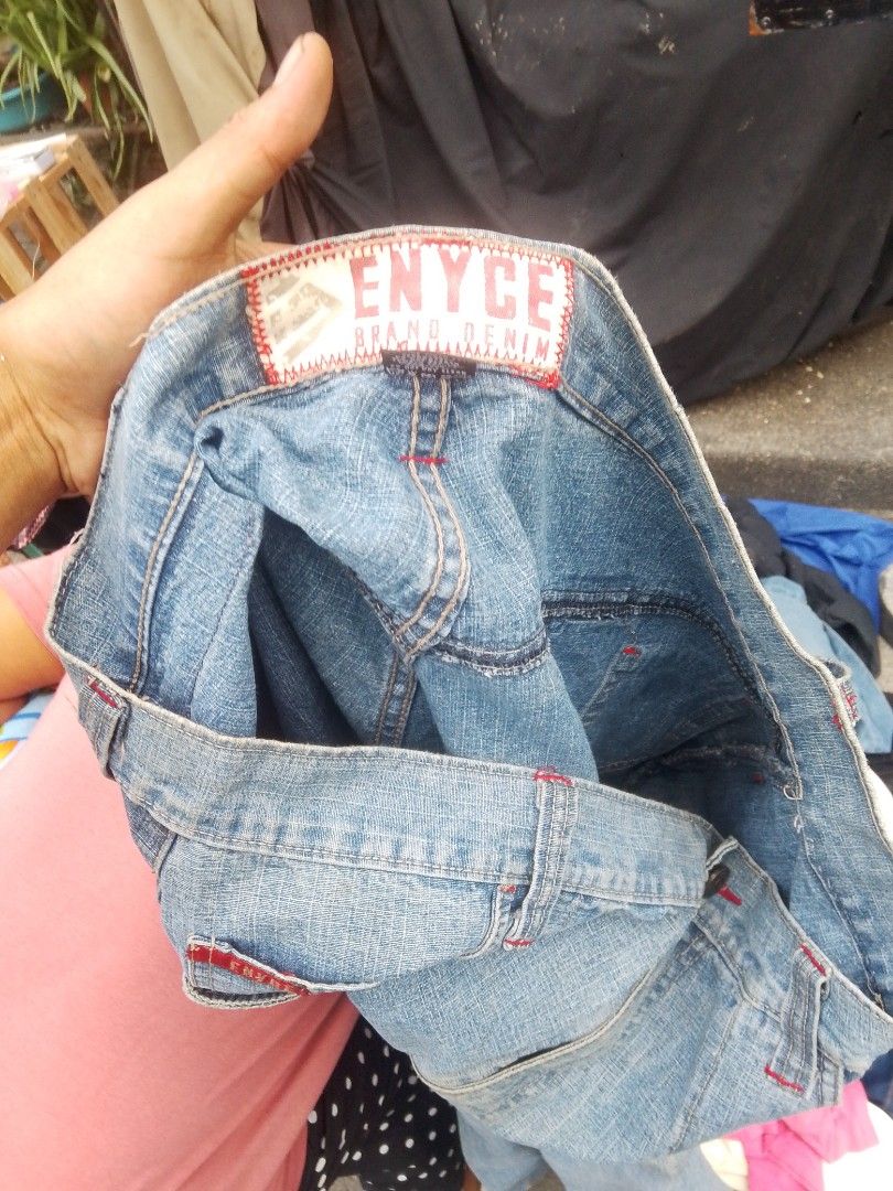 Enyce Brand Denim Jeans (Category: Jeans) located in Quezon City. Submitted by theoneshop1 (Listing ID 1465674427, Image 2). Description: - Brand: Enyce Brand Denim - Style: Classic wide leg fit - Wash: Light wash denim - Details: Eye-catching contrast red stitching on seams and pockets - Branding: Signature Enyce tag on back pocket and waistband - Closure: Zip fly with button closure - Material: Sturdy, high-quality denim.