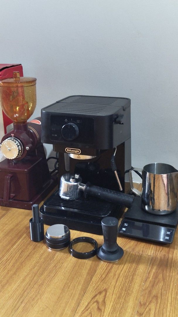 Espresso Machine Coffee Complete Set (Category: Coffee Machines & Makers) located in Manila. Submitted by deerondee (Listing ID 1465601699, Image 1). Description: Complete home coffee setup, ready to use - DeLonghi espresso machine with portafilter and steam wand - Red electric coffee grinder with amber bean hopper - Digital scale and stainless steel milk pitcher included - Extras included: dual-ended tool, metal distributor, dosing ring, and bla