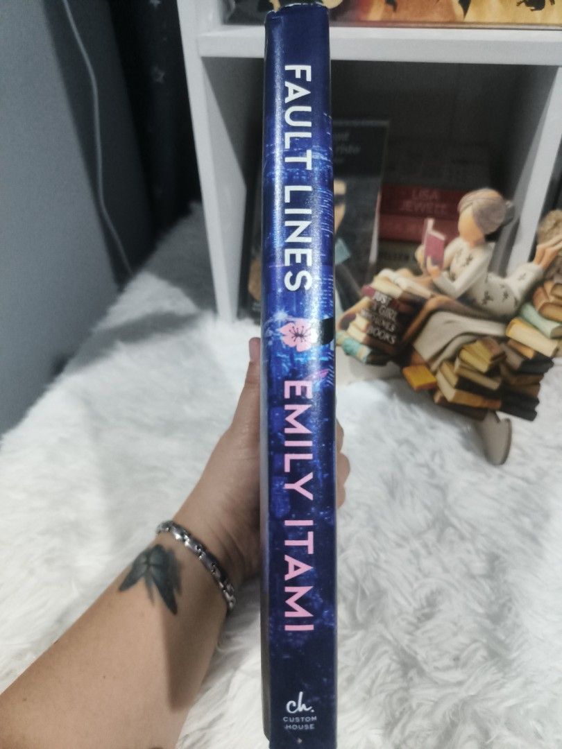 Fault Lines by Emily Itami Hardcover Novel (Category: Storybooks) located in Cabuyao City. Submitted by chaptersandwonders143 (Listing ID 1465618966, Image 3). Description: - Title & Author: Fault Lines by Emily Itami - Format: Hardcover edition published by Custom House - Aesthetics: Vibrant blue dust jacket with a striking Tokyo night skyline cover art and lovely pink endpapers - Condition: Clean pages and solid binding, well-maintained - Genre