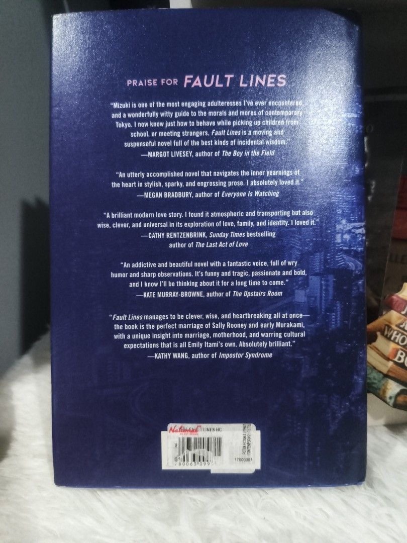 Fault Lines by Emily Itami Hardcover Novel (Category: Storybooks) located in Cabuyao City. Submitted by chaptersandwonders143 (Listing ID 1465618966, Image 2). Description: - Title & Author: Fault Lines by Emily Itami - Format: Hardcover edition published by Custom House - Aesthetics: Vibrant blue dust jacket with a striking Tokyo night skyline cover art and lovely pink endpapers - Condition: Clean pages and solid binding, well-maintained - Genre