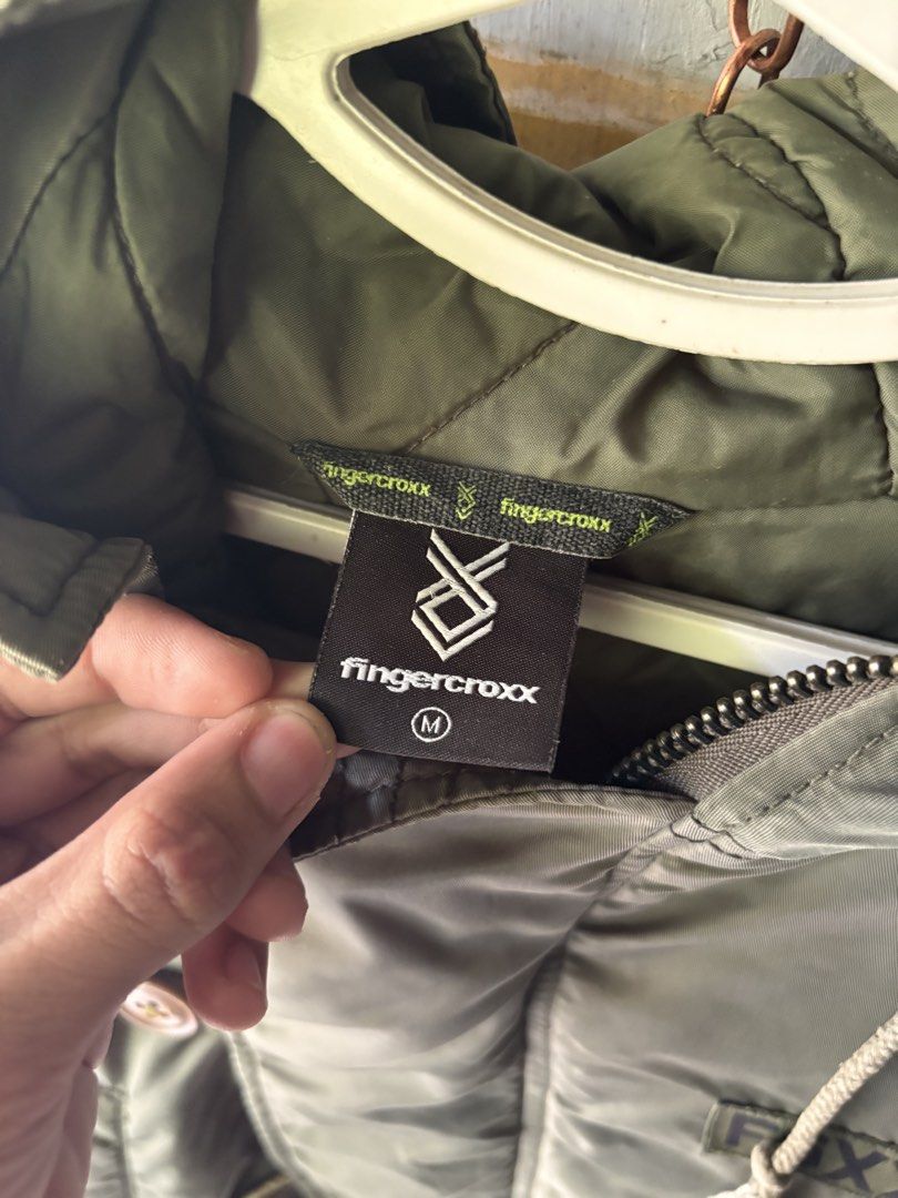 fingercroxx Army Green Hooded Jacket Size M (Category: Coats, Jackets and Outerwear) located in Manila. Submitted by joshuadexter-manuel (Listing ID 1465668558, Image 2). Description: - Brand: fingercroxx - Color: Army green - Size: Medium (Regular fit) - Closure: Front zipper and button - Details: Multiple pockets, FGXX ARMY chest patch, drawstring hood and hem - Style: Warm, chunky, and great for layering over hoodies and sweaters.