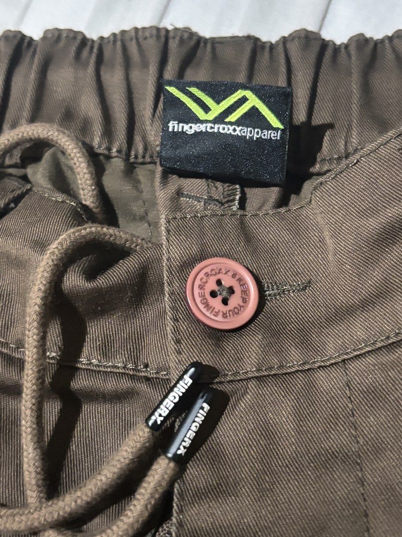 Fingercroxx Ver-Tex Series Brown Pants (Category: Trousers) located in San Jose del Monte. Submitted by icarus.falls (Listing ID 1465723224, Image 3). Description: - Brand: Fingercroxx (Ver-Tex series) - Color: Dark Brown - Size: 165/66Y - Material: Comfortable cotton and polyester blend - Waist: Adjustable drawstring with branded aglets and button closure - Fit: Relaxed fit with subtle front pleating - Detail: Unique text label patch on the back