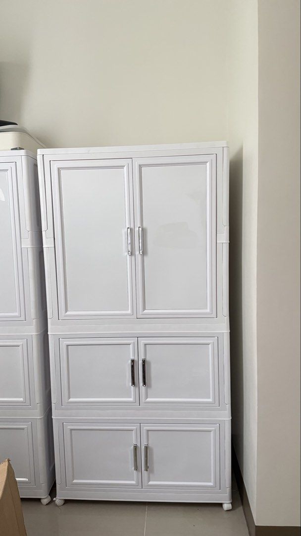 Foldable Cabinet with free Hangers (Category: Shelves, Cabinets & Racks) located in Manila. Submitted by wpfmapdl (Listing ID 1465756582, Image 1). Description: bought for 2.7k - Type: White plastic multi-tier cabinet with doors and wheels - Dimensions: 75cm wide x 40cm deep x 142cm tall - Hanging Section: 105cm high (ideal for dresses and pants) - Lower Storage: 35cm of extra storage space at the bottom - Design: Clean white finish with stylish 