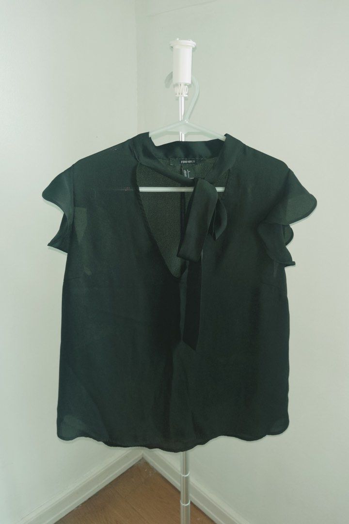 Forever 21 Black Tie-Neck Blouse (Category: Blouses) located in Manila. Submitted by designforhumanity (Listing ID 1465625463, Image 1). Description: - Brand: Forever 21 - Color: Classic Black - Material: Lightweight, sheer chiffon - Details: Short flutter sleeves with ruffled trim, cutout neckline with built-in tie ribbon - Fit: Loose, relaxed body with standard hemline - Condition: Clean stitching along all seams - Style: Great for casual every