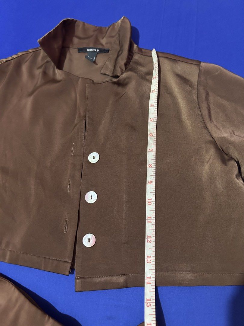 Forever 21 Brown Satin Coordinates (Category: Sets or Coordinates) located in Silang. Submitted by wearchiangmai__ (Listing ID 1465647002, Image 3). Description: - Brand: Forever 21 - Set includes: Short-sleeve button-up top and mini skirt with side slit - Material: Silky smooth brown satin - Details: Chic pearl-style buttons - Size: S (both pieces) - Condition: Great, perfect outfit for outings and dates.