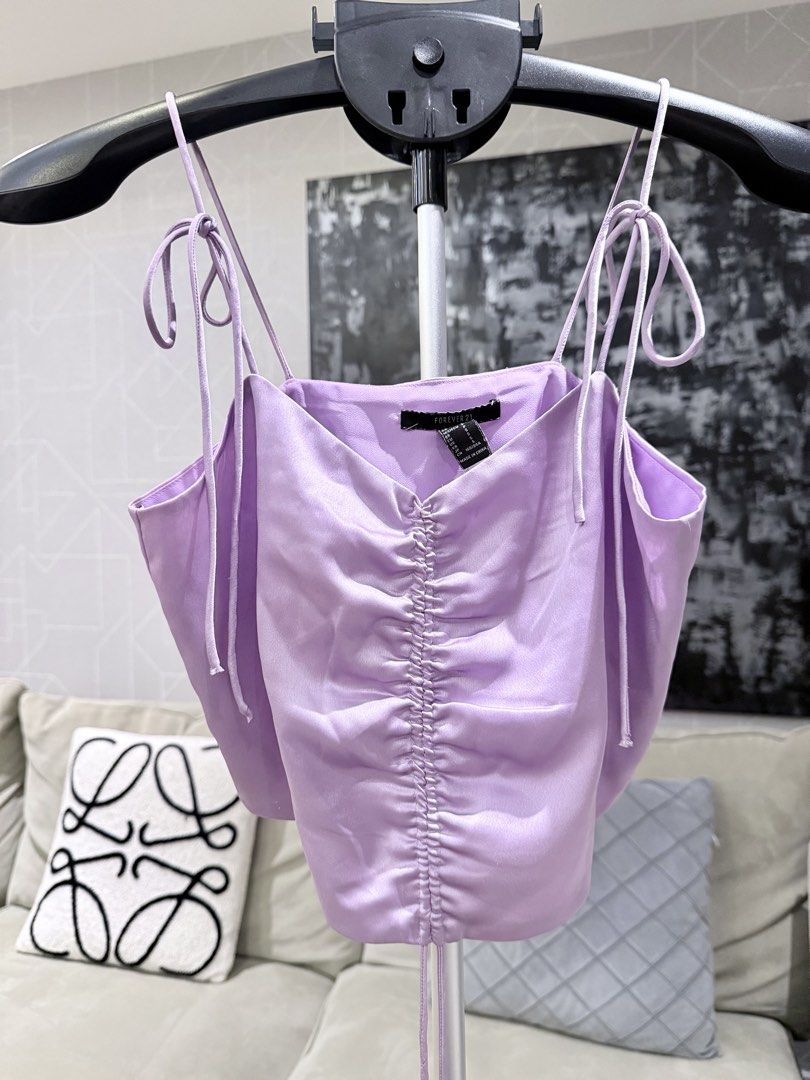Forever 21 lilac self tie satin top (Category: Sleeveless) located in Taguig. Submitted by annebydesign (Listing ID 1465691409, Image 2). Description: Hi all. Selling this Forever 21 Lilac satin camisole self tie top for ₱300 •Like new. Matagal na to sakin -I think this is from sm aura or US limot k na •Fits small to med •self tie sa shoulder and front Loc: Taguig BGC Mop: GCash/ Bank transfer/ COD Mod: Courier or Rider pick up.