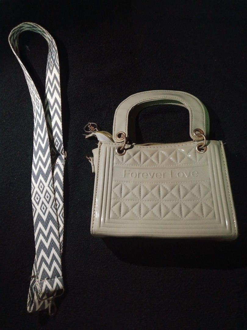 Forever Love Handbag with Patterned Strap (Category: Shoulder Bags) located in Rizal. Submitted by hawt_sawl (Listing ID 1465688211, Image 1). Description: Chic light grey patent handbag featuring a 'Forever Love' debossed design and gold-tone hardware. Comes with dual top handles and a stylish detachable zigzag strap. Secure zip top closure. Perfect for everyday use or gifting!.