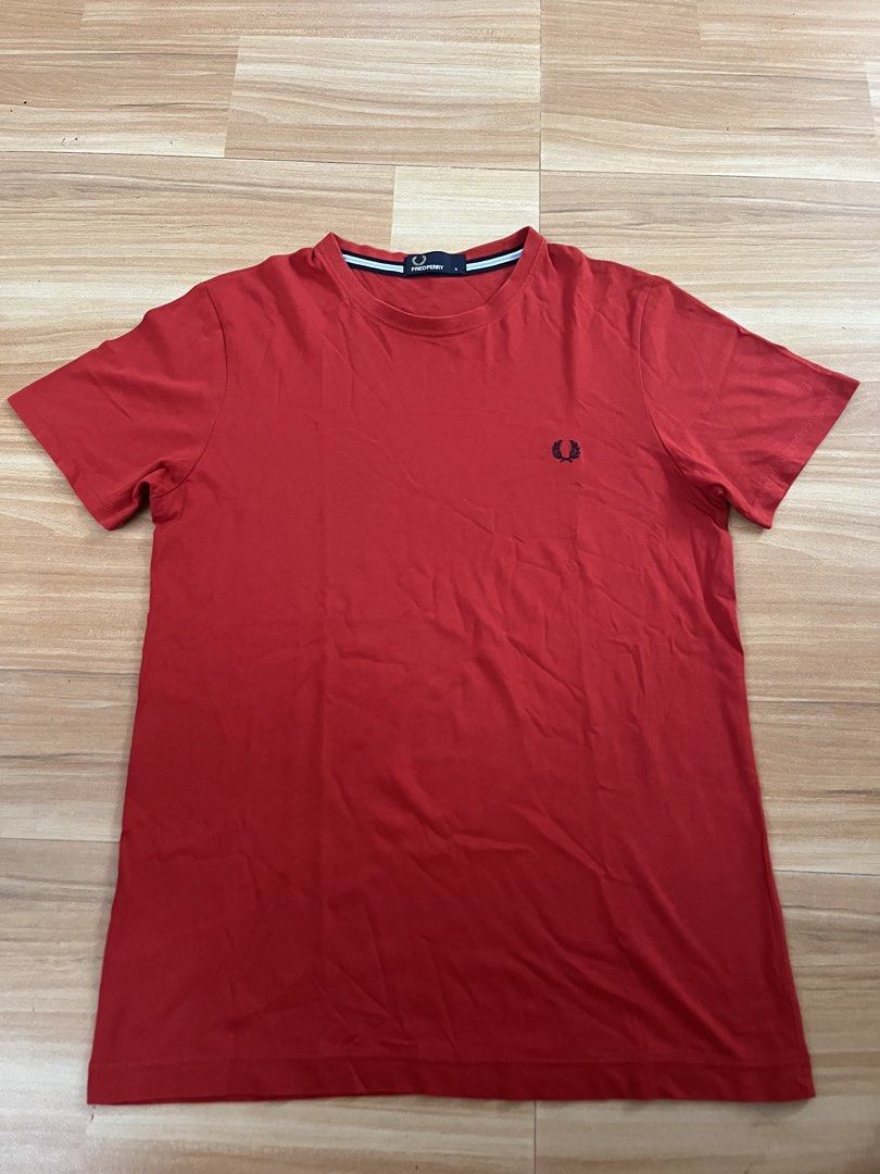 Fred Perry Red T-Shirt Size S (Category: Tshirts & Polo Shirts ) located in Victorias. Submitted by lan1877 (Listing ID 1465675465, Image 1). Description: - Brand: Fred Perry - Style/Model: M6334 - Size: Small - Color: Red with dark blue laurel wreath embroidery - Details: Contrast tipping on inner collar tape, clean cotton fabric, regular fit, straight hem - Condition: Excellent casual wear staple.